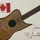 A painting that portrays the Canadian flag and a guitar with a purple star.